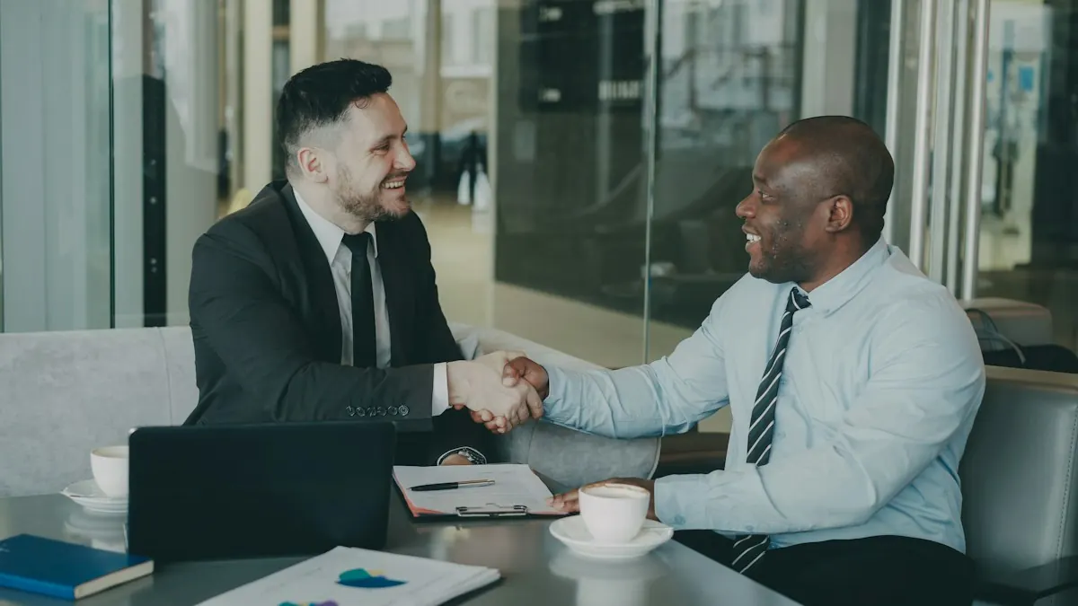 Two professionals shaking hands across a meeting table