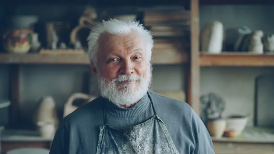 Smiling older craftsman in his workshop